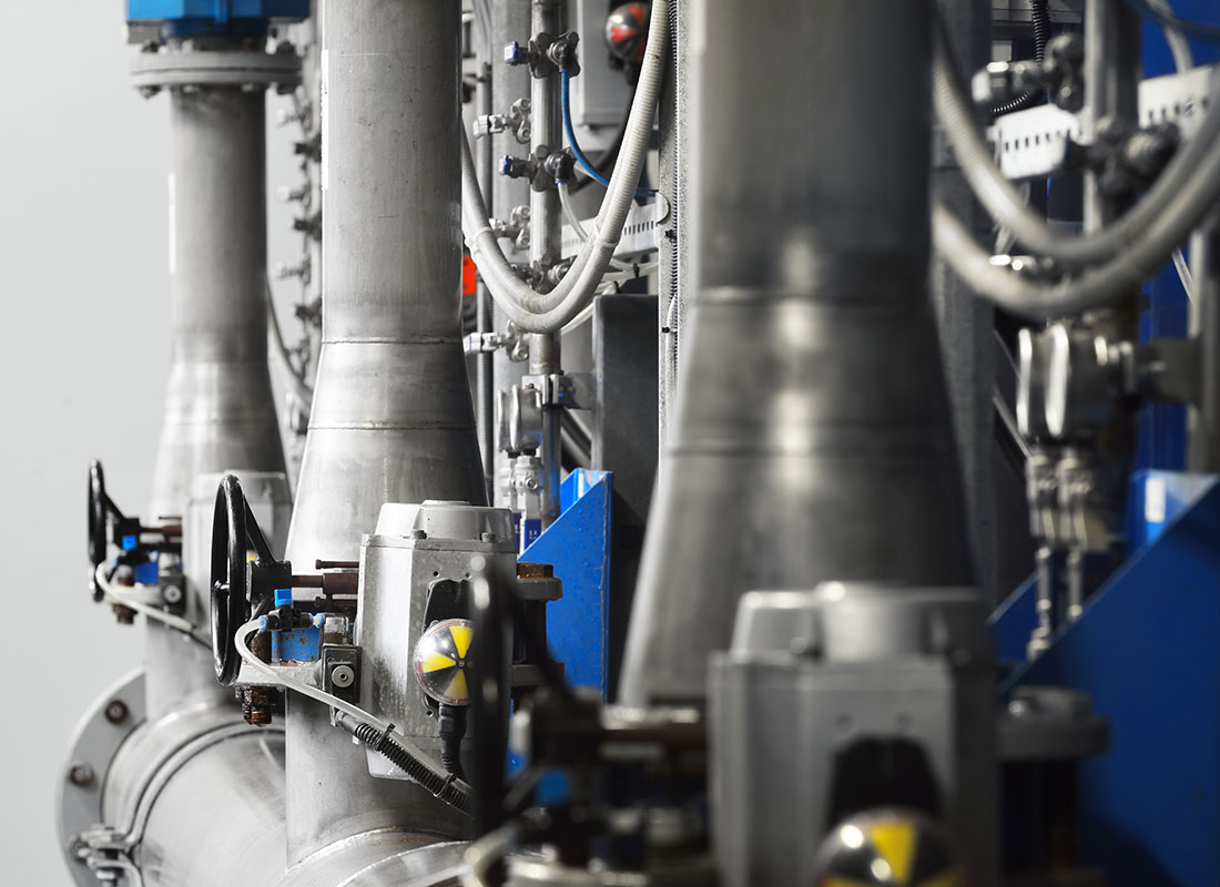 Systems Breakdown Insurance - Close-up of Shiny Steel Metal Pipes, Piping, and Technology in a Biotechnology Lab