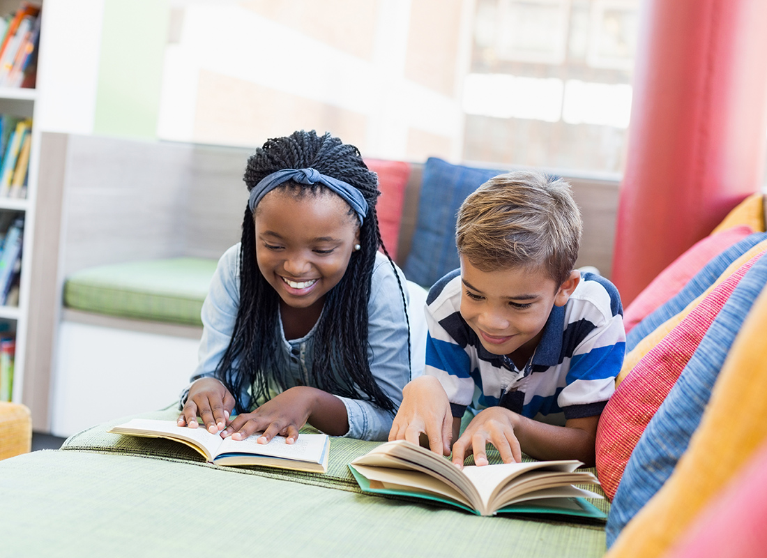 Read our reviews - Kids Reading Books on a Colorful Sofa